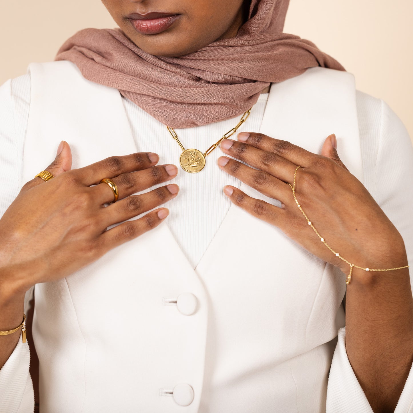 18k gold plated paperclip chain necklace with a 22 mm round coin medallion featuring an embossed olive branch.