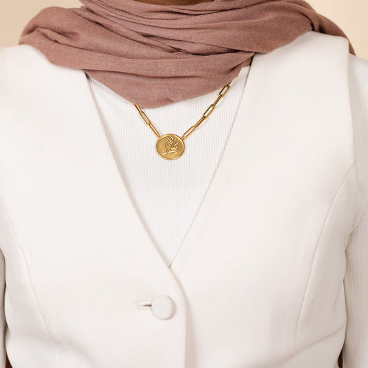 18k gold plated paperclip chain necklace with a 22 mm round coin medallion featuring an embossed olive branch.