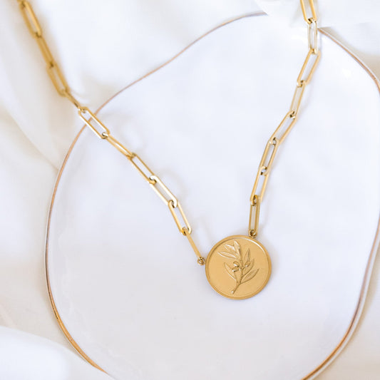 18k gold plated paperclip chain necklace with a 22 mm round coin medallion featuring an embossed olive branch.